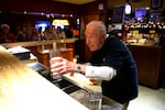 John Spaccarotelli, 94-year-old owner and bartender at what many call the "last roadhouse in Seattle," tends bar on Friday, Dec. 19, 2025, at the Shanty Tavern in the Lake City neighborhood.