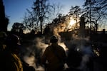 Firefighters put out a hot spot at a home destroyed by the Eaton Fire, Tuesday, Jan. 14, 2025, in Altadena, Calif.