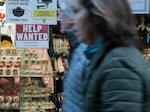 A 'help wanted' sign is displayed in a window of a store in Manhattan, New York City, on Dec. 2, 2022.