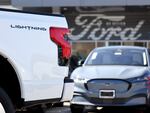 A Ford F-150 Lightning electric pickup truck is displayed for sale at a Ford dealership on Aug. 21 in Glendale, Calif. Ford says it is upending its electric vehicle strategy for North American vehicles to focus on hybrids, citing consumers' demands for affordability and longer ranges.