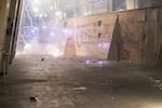 Fireworks go off outside the boarded up federal courthouse during 4th of July demonstrations against systemic racism and police violence. Protesters ate food, danced, burned American flags and set off fireworks before Portland Police and federal law enforcement used tear gas and impact munitions to disperse the crowd.