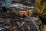 A firefighter works the line. 
