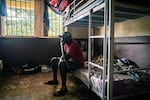 Kush user Ahmed Kang, 30, sits on his bunk at the City of Rest rehabilitation center in Grafton, Sierra Leone. Kang, who is on his third stint at the facility, says it took ten police officers to drag him inside. "It's so addictive," says Kang. "And it costs less than a pack of chewing gum. How can you even control that?"