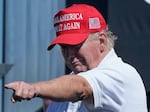 Former President Donald Trump points at a crowd at a golf tournament at Trump National in Bedminster, N.J., on Sunday.
