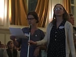 Jessica Applegate and Amanda Jarman deliver their demands for more stringent air pollution controls to public officials at an open house Tuesday in Portland.