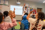 FILE - Third grade teacher Clemente Campos calls for attention on the first day of school at Cornelius Elementary School in Cornelius, Ore., in September.