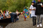 After the Portland All Nations Canoe Family received permission to land at Cathedral Park under St. John's Bridge in Northeast Portland on Sunday Sept. 8, 2024, elders and other attendees on the beach helped pull their canoe ashore.