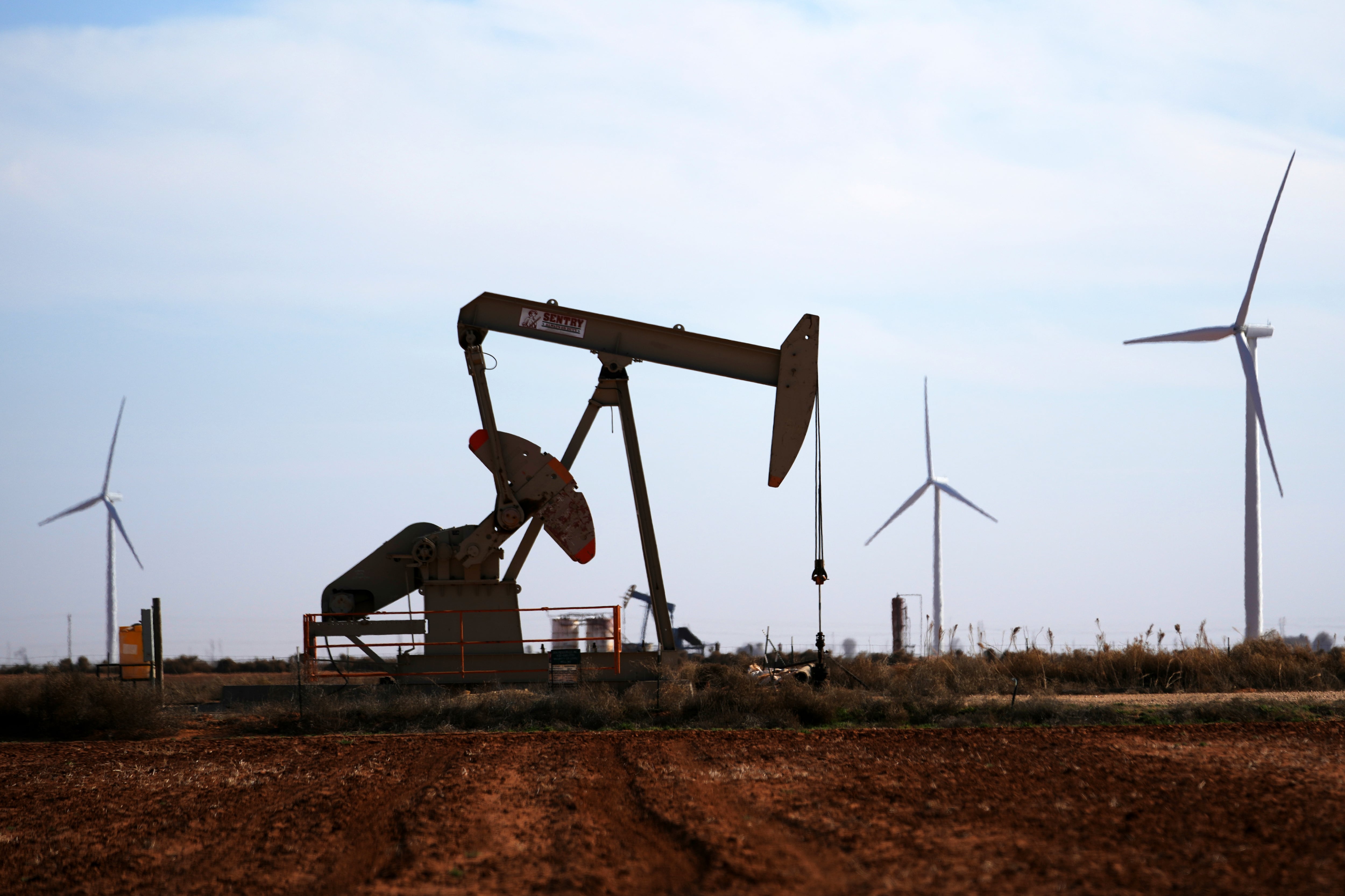 Wind turbines behind a pumpjack on Wednesday, Feb. 26, 2025, in Lamesa, Texas. The state is an oil and gas powerhouse, but has also become the nation's biggest producer of wind and solar energy.