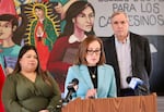 Rep. Andrea Salinas, D-Oregon, speaks to reporters with Isa Peña of Innovation Law Lab and Sen. Jeff Merkley, D-Oregon, behind her in Woodburn on Feb. 13, 2026.
