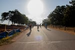Will Rogers Elementary students cruise down a hill on their route to school after a routine brake check. Parents, students and a car monitor ride about a mile from the park to the school as part of what’s called a bike bus.