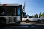 Cars and a TriMet bus drive down Southeast Division Street at 157th Avenue in Portland, Oregon, Wednesday, July 11, 2018.