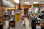 The original F.H. Steinbart sign hangs in the Portland, Ore., store as shipping manager Jeff Hoffman talks on the phone with a customer on Dec. 4, 2025. Open since 1918 and the oldest home brew shop in the country, F.H. Steinbart is closing this month due to a shifting industry where it’s increasingly difficult to survive as a brick-and-mortar shop.