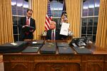 President Donald Trump signing executive orders in the Oval Office of the White House in Washington, DC, on January 20, 2025.