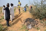 People visit the site of a U.S. airstrike in Jabo, Nigeria, Friday, Dec. 26, 2025.