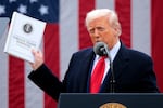 Trump holds up a report as he speaks at an event in the Rose Garden at the White House in Washington, D.C., on April 2, 2025.