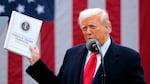 Trump holds up a report as he speaks at an event in the Rose Garden at the White House in Washington, D.C., on April 2, 2025.