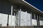 A tarp covers the facade of the John F. Kennedy Memorial Center for the Performing Arts in Washington, DC, on June 13. A federal judge has asked the arts complex's leadership to explain the purpose of the tarp and the surrounding scaffolding.