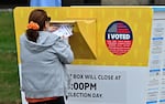 A voter puts their ballot in a drop box in Norwalk, Calif., during early voting in Los Angeles County. People who vote in the 2024 general election can track their ballots as they move through the system.