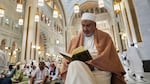 A Muslim pilgrim reads a copy of the Quran at the Grand Mosque during the annual Hajj pilgrimage in Mecca, Saudi Arabia.