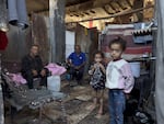 Subhi Shurabasi, a 60-year-old grandfather, shelters with his sons, their wives and his grandchildren inside the ruins of their destroyed home in al-Shujaiya, on May 31.