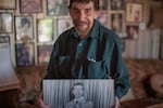 Malafouris holds a photo of himself from his show business days. He retires this year from the furniture business he has owned, Gordon's Fireplace Shop, for 61 years.