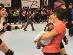 A young fan takes in the roller derby action.