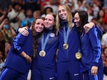 Gold Medalists (from left to right) Regan Smith, Lilly King, Gretchen Walsh and Torri Huske of Team United States celebrate on the podium during the medal ceremony after the Women’s 4x100m Medley Relay Final on Sunday at the Paris Olympics.