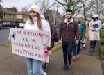 Teaonna Fuller of Lincoln City shows her support for HB 2002 at the Oregon State Capitol in Salem on March 20, 2023. The bill would require health care plans in Oregon to include reproductive and gender-affirming care.