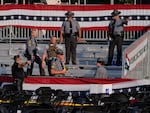 Law enforcement officers gather at the campaign rally site for Republican presidential candidate former President Donald Trump on Saturday, July 13, 2024, in Butler, Pa. Trump's campaign said in a statement that the former president was "fine" after a shooting at his rally in Butler.