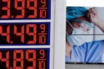 Prices of $3.99, $4.49 and $4.89 are displayed on a sign at a gas station.