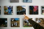 Daryl McCool points to photographs displayed in her rebuilt home in Superior, Colorado. McCool lost the small, single-story historic miner’s shack where she and her family had lived for 25 years when it was destroyed in the Marshall Fire on Dec. 30, 2021. The fire is part of the broader climate-related costs facing Colorado communities.