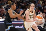 Caitlin Clark of the Indiana Fever, right, drives to the basket against Sydney Taylor of the Chicago Sky on Aug. 23.