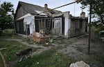A photograph taken on Sept. 27 shows a heavily damaged house in the recently liberated village of Vysokopillya, Kherson region, amid the Russian invasion of Ukraine. Russian-backed authorities are urging residents of the region to evacuate.