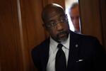 Sen. Raphael Warnock, D-Ga., leaves a Senate Democratic meeting at the U.S. Capitol Building on Oct. 3. A Baptist pastor, Warnock said maybe his GOP colleagues would come around.