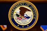 FILE - The U.S. Department of Justice logo is seen on a podium before a news conference at the Justice Department in Washington, on May 6, 2025.