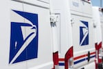 FILE - Delivery vans are parked during a protest staged as part of a countrywide National Day of Action Tuesday, July 28, 2026, outside the main United States Postal Service headquarters in northeast Denver.