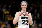 FILE - Iowa guard Caitlin Clark makes a heart gesture after the team's NCAA college basketball game against Michigan, Thursday, Feb. 15, 2024, in Iowa City, Iowa. Clark broke the NCAA women's career scoring record.