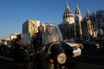 Commuters drive past Saint Sarkis church and a mural of the late Iranian revolutionary founder Ayatollah Khomeini in downtown Tehran, Iran, Wednesday, Feb. 25, 2026.