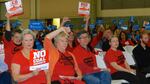 Supporters of a coal export project in Longview wore blue shirts and waved blue signs while opponents protested the project with red shirts and signs.