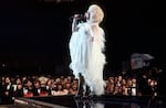 Country singer Dolly Parton performs onstage, circa 1977.