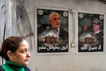 A woman walks past posters depicting Yahya Sinwar, the head of Hamas in Gaza, plastered on a wall in the Burj al-Barajneh camp for Palestinian refugees in Beirut's southern suburb on Feb. 5.