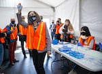 Gov. Kate Brown thanks workers drawing up COVID-19 vaccines as she tours a drive-thru vaccination clinic at Portland International Airport, April 9, 2021. Now a lawsuit seeks to overturn the governor's vaccine mandate.