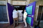Chester County, Pa., workers transport mail-in and absentee ballots to be processed at West Chester University, Wednesday, Nov. 4, 2020, in West Chester.