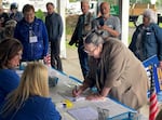 Gubernatorial candidate Betsy Johnson signs a petition to put her name on the November ballot on June 14, 2022. Johnson says she has now submitted enough signatures to qualify.