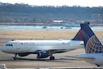 A Delta plane taxis to its gate at Ronald Reagan Washington National Airport after landing on Jan. 30 in Arlington, Va.