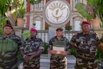 CAPSAT military unit commander Col. Michael Randrianirina, center, reads a statement saying that the armed forces are taking control of the country from the steps of the Presidency in Antananarivo, Madagascar, Tuesday, Oct. 14, 2025.