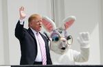 President Trump and the Easter Bunny wave during the annual White House Easter Egg Roll on the South Lawn on April 22, 2019.