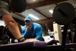 Personal Trainer Turk Fickling watches Ben Williams lift weights. Williams has been working with Fickling for two years.