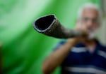 Abraham Ribak , an Israeli, blows a shofar, a musical instrument used in Jewish religious ceremonies made from the horn of a Ram.