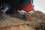 Farmers offload livestock manure from a truck, that will be used to fertilize crops due to the increased cost of fertilizer that they say they now can't afford to purchase, in Kiambu, near Nairobi, in Kenya Thursday, March 31, 2022. Russia's war in Ukraine has pushed up fertilizer prices that were already high, made scarce supplies rarer still and squeezed farmers, especially those in the developing world struggling to make a living. (AP Photo/Brian Inganga)